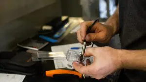 man's hands measuring a package prototype