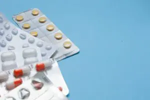 Assorted pharmaceutical blister packaging on a blue background