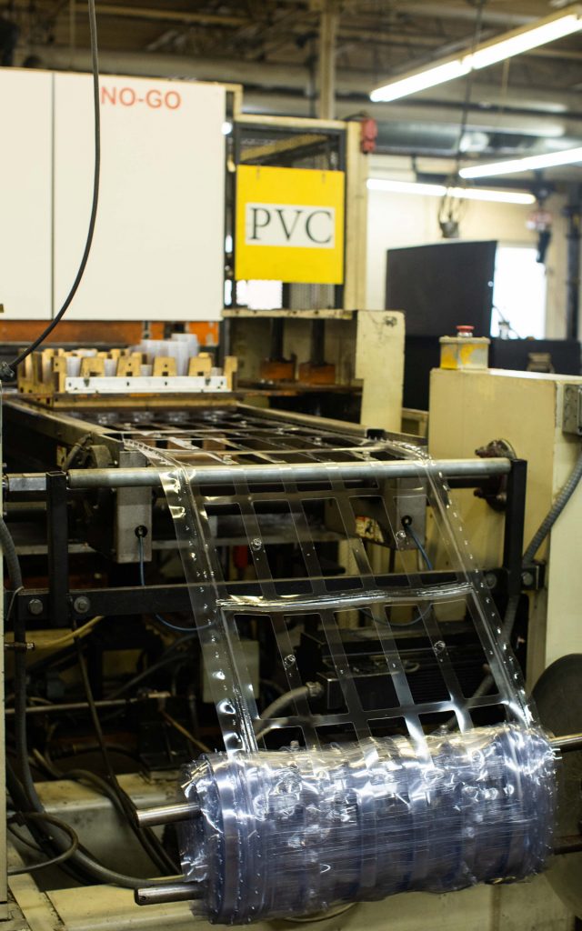 machine creating PVC packaging