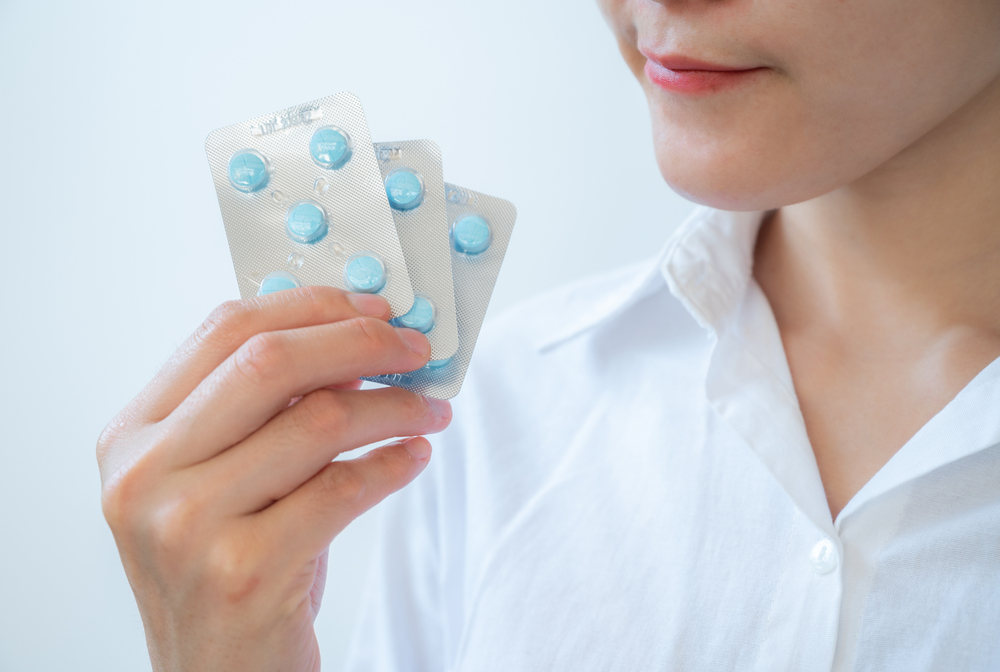Woman holding a blister pack with pills