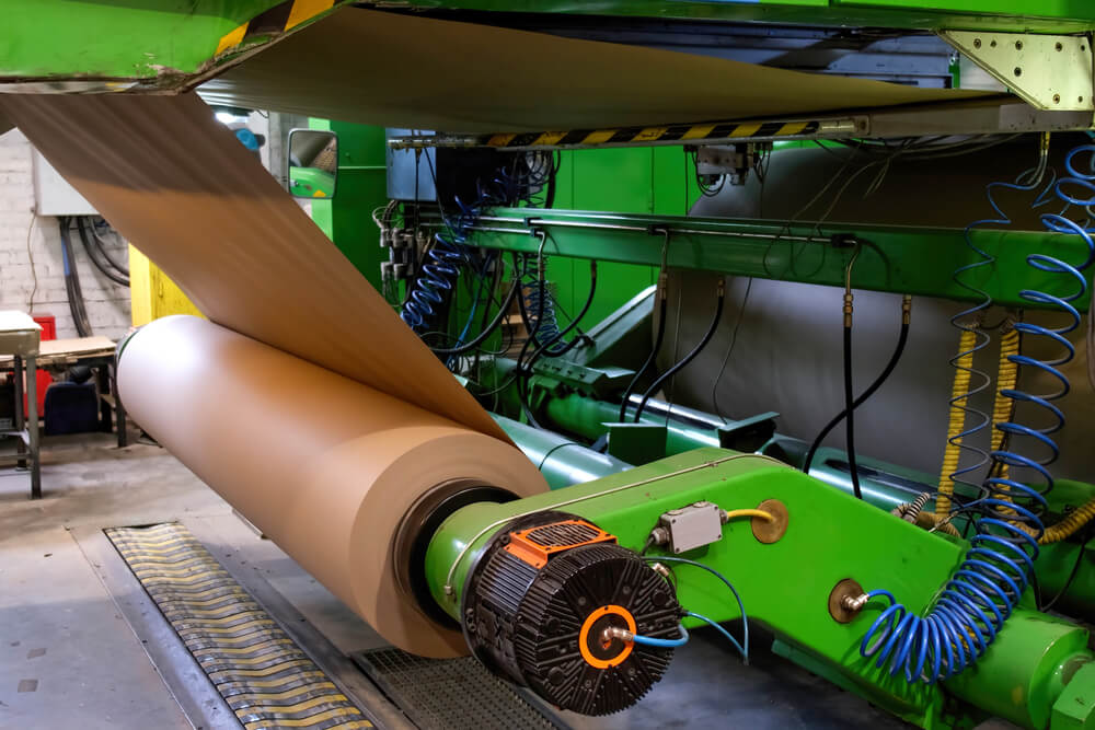 corrugated cardboard paper being rolled on a machine
