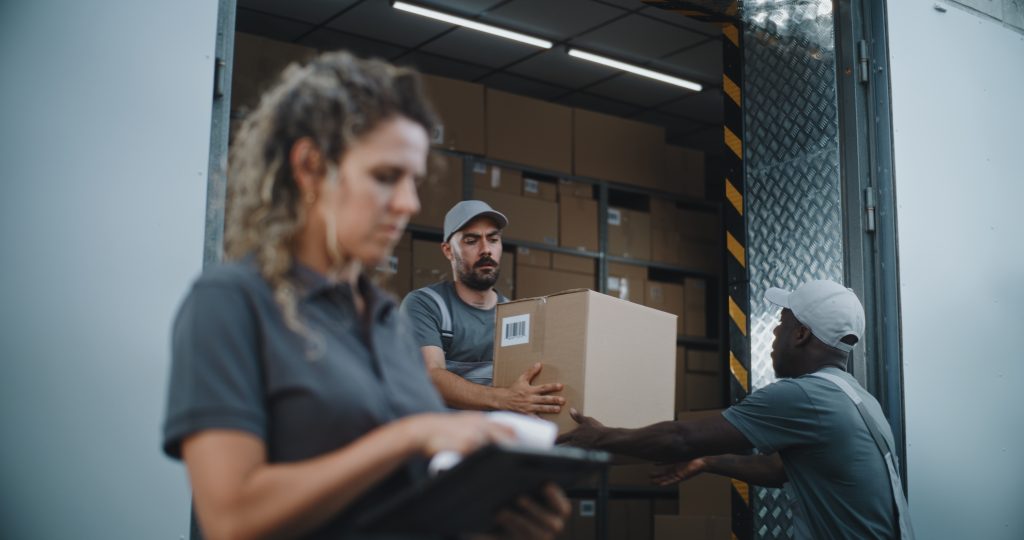 Logistics employees in the packaging industry with boxes