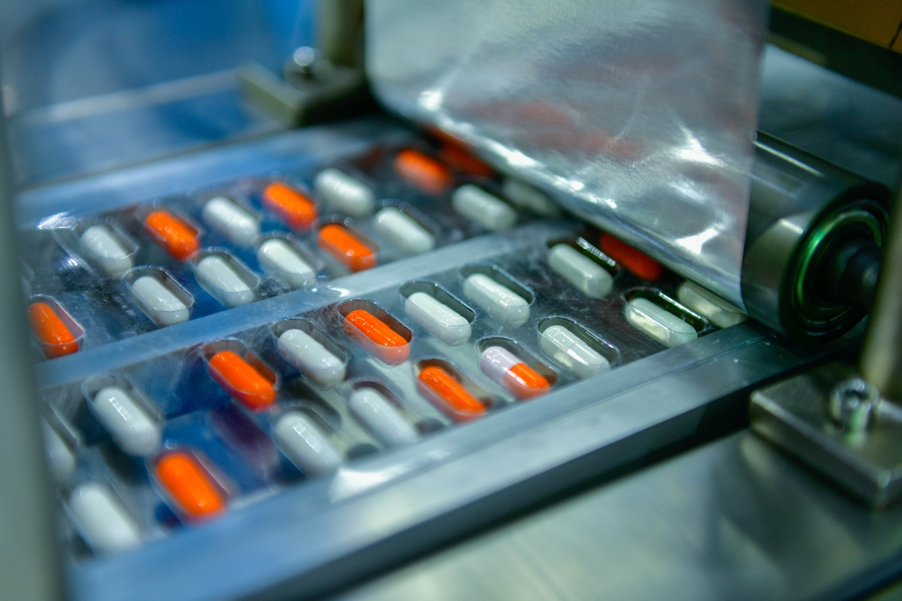 Pills being sealed in pharmaceutical blister packaging